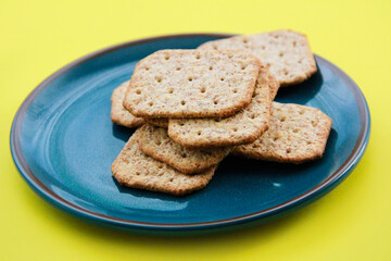 square dry grain cookies in a decorative plate