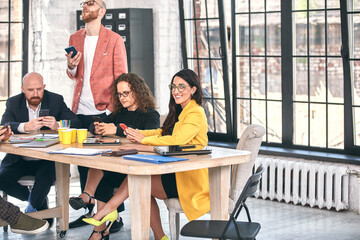 Shot of a group of young business professionals having a meeting. Diverse group of young designers smiling during a meeting at the office.