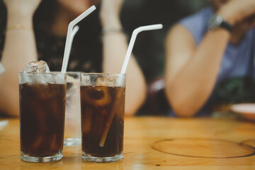 Two glasses of soft drink with ice on table