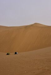 Fototapeta na wymiar Two modern day tents pitched in the Namib Desert which is the oldest desert in the world