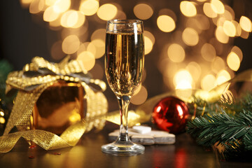 selective focus of glasses full of champagne against christmas lights