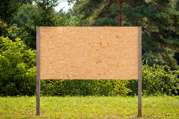 Wooden blank billboard with empty space in a park