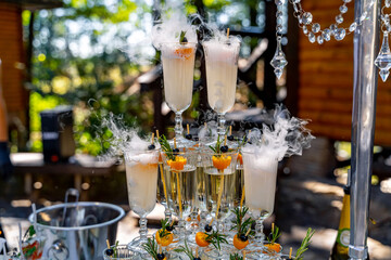 Champagne slide. Pyramid or fountain made of champagne glasses. Wedding table decoration.