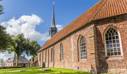 Fototapeta na wymiar Panorama of the historic church in the center of small town Niehove, Netherlands