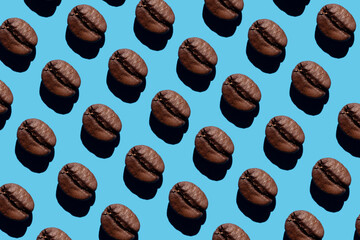 Coffee beans creative pattern isolated on blue background. Top view. roasted coffee beans, can be used as a background