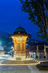 Illuminated Sebilj ottoman-style wooden fountain at sunrise, Bascarsija old bazar, Sarajevo, Bosnia...