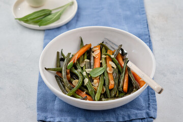 Green beans with carrots cooked with olive oil and sage. Healthy food.