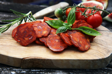 Sliced chorizo salami. Spanish traditional chorizo sausage for appetizer on wood