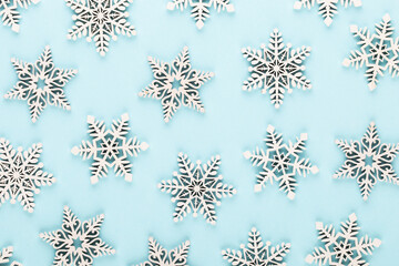 Christmas background. White snow decorations on a pink background.