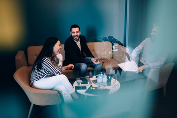 Cheerful team of managers laughing together in rest room