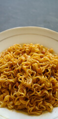 stock photo tasty fried noodle on a white plate and a stone pad