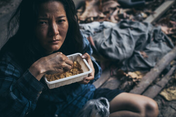 poor people,homeless or beggar begging for help sitting at dirty slum.concept for poverty...