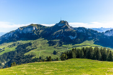 Fototapeta premium The Alp with cow stables and tiny cottages on top of the Appenzeller mountains in autumn