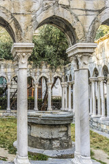 Fototapeta premium 12th century Ruins of old cloisters standing in a small garden in Genoa, Italy.