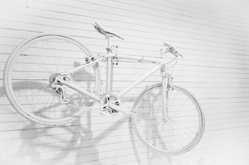 Fototapeta na wymiar White Bicycle on the white wooden wall
