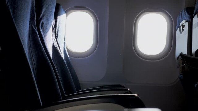 Empty aircraft seats and Seat belt with sunlight from the airplane window. 