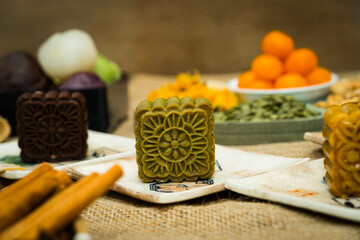 Mid-Autumn Festival moon cake, colorful food and drink on burlap background