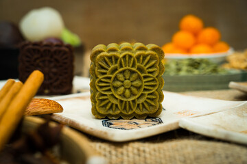 Mid-Autumn Festival moon cake, colorful food and drink on burlap background