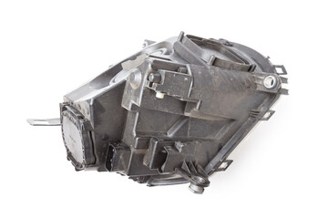 Spare part made of black plastic, rear view on white background in a photo studio for a catalog - a xenon headlight inside electrical systems and optical equipment assemblies of a lamp and reflectors