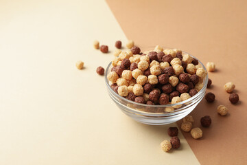 Bowl with corn balls on two tone background