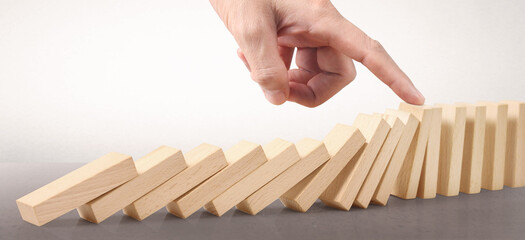 Domino wooden falling over effect stopped by unique