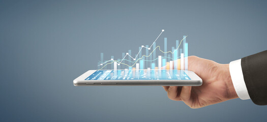 Businessman plan graph growth  increase of chart positive indicators in his business, tablet in hand