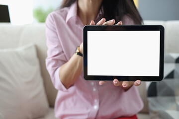 Woman holds black tablet in her hands. Review of technique by blogger concept