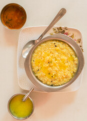 South Indian Pongal with chutney and ghee on a white background