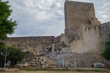 Walls & tower of ancient fortress Corycus, former important port & commercial town on Mediterranean sea, Kizkalesi, Turkey. It was founded as pirate base, & then conquered by Byzantine Empire