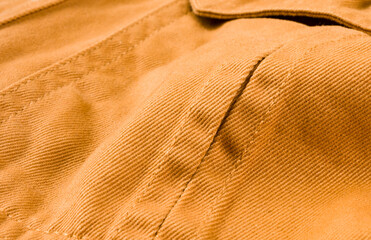 clothing items stonewashed cotton fabric texture with seams, clasps, buttons and rivets, macro