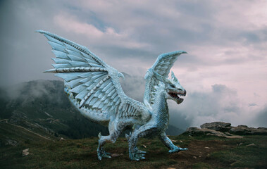 Fantasy dragon stands on the top of the mountain. A huge dangerous animal with large, sharp wings....