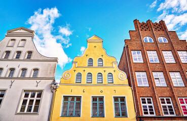 Three colorful old gabled house facades in the old town of Wismar.
