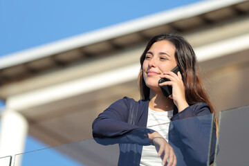 Apartment renter calling on phone in a balcony