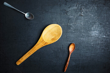 A wooden spoon on a black background