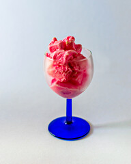 Delicious, pink strawberry ice-cream in a transparent wine glass.