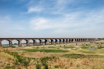 Long stone arched railway bridge in Daund, Maharashtra, India.