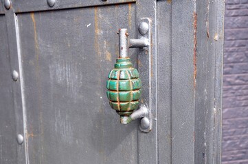 door knob doorhandle on the thick metall door looks like grenade weapon