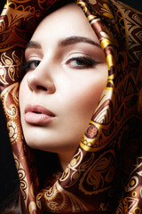 girl in a golden scarf. beautiful young woman