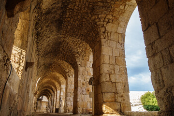 Passage inside of medieval castle Kizkalesi, near Kizkalesi, Turkey. There are stone arch colonnade & embrasure. Fort was founded in antiquity by pirates, then belonged to Byzantines & after to Osmans