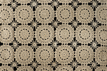 Old handmade Lace pattern background on a black background.