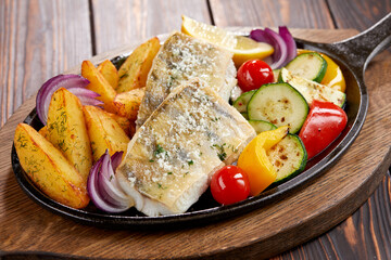 fish with grilled vegetables on the pan