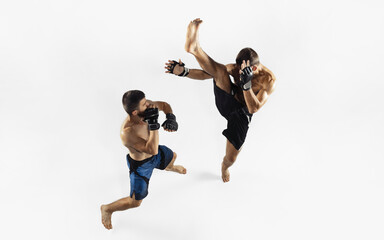 Two professional MMA fighters boxing isolated on white studio background. Top view of couple of...