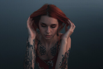 girl touches her red hair