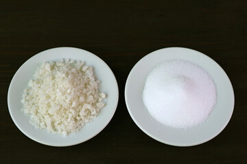 Sea Salt and Table Salt Isolated on Black Background
