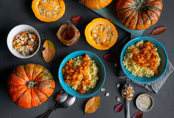 Millet porridge with pumpkin and honey in blue bowls, raw pumpkins and seeds, top view