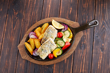 fish with grilled vegetables on the pan