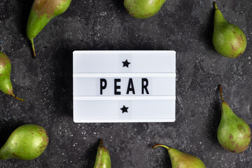 Lettering pear with green pears on a dark background