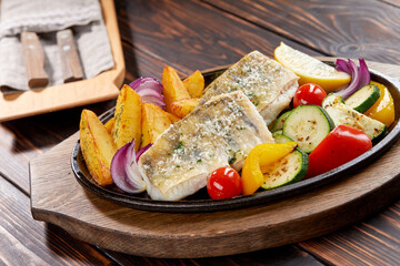 fish with grilled vegetables on the pan