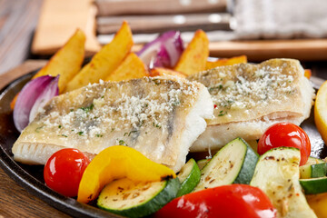 fish with grilled vegetables on the pan