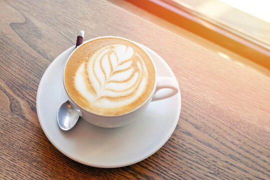 Cappuccino coffee dressing with leave shape of latte art